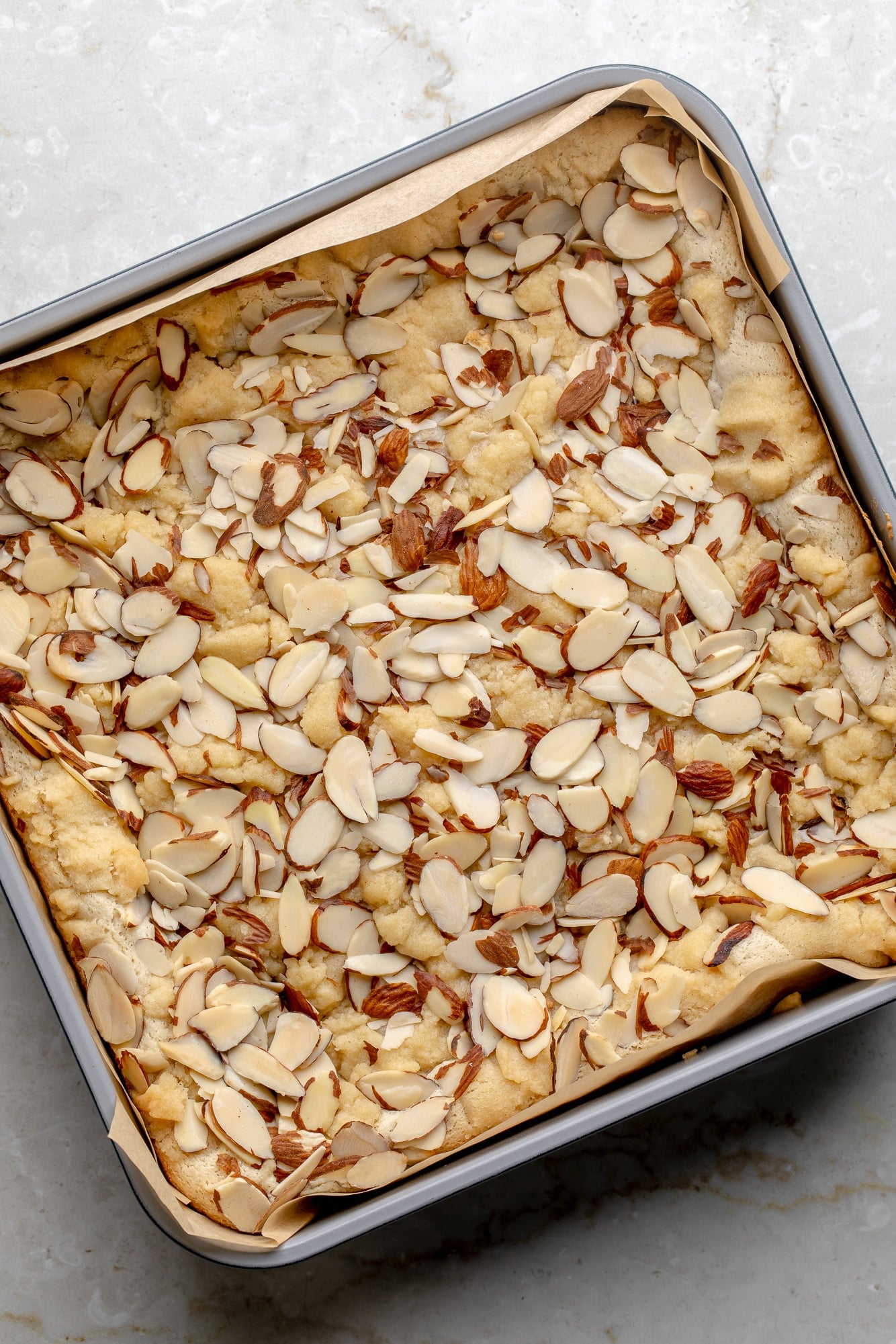 overhead view of baked vegan almond croissant bars in a baking pan.
