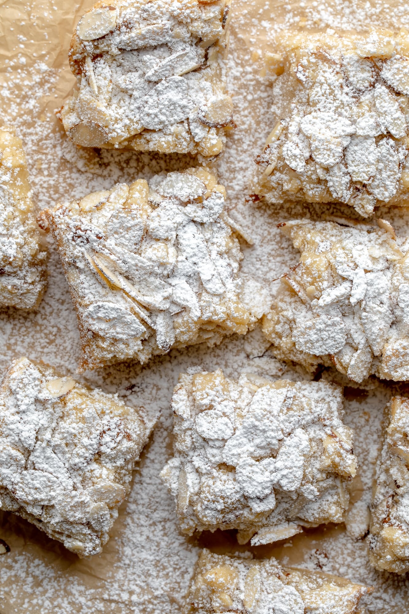 overhead view of vegan almond croissant bars topped with powdered sugar.