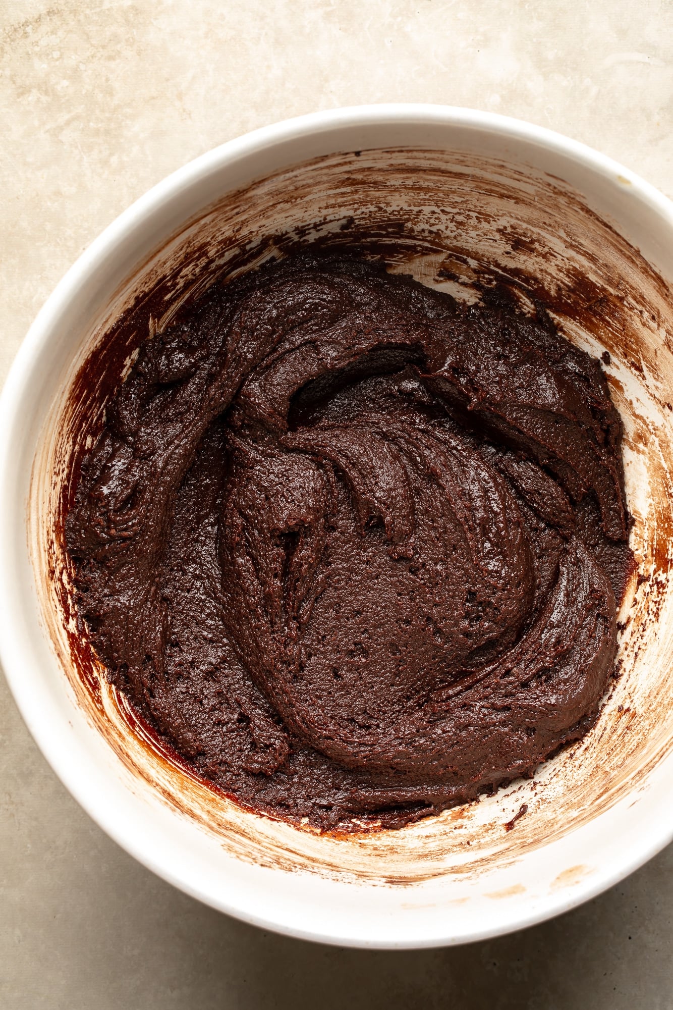overhead view of vegan brownie batter in a large bowl.