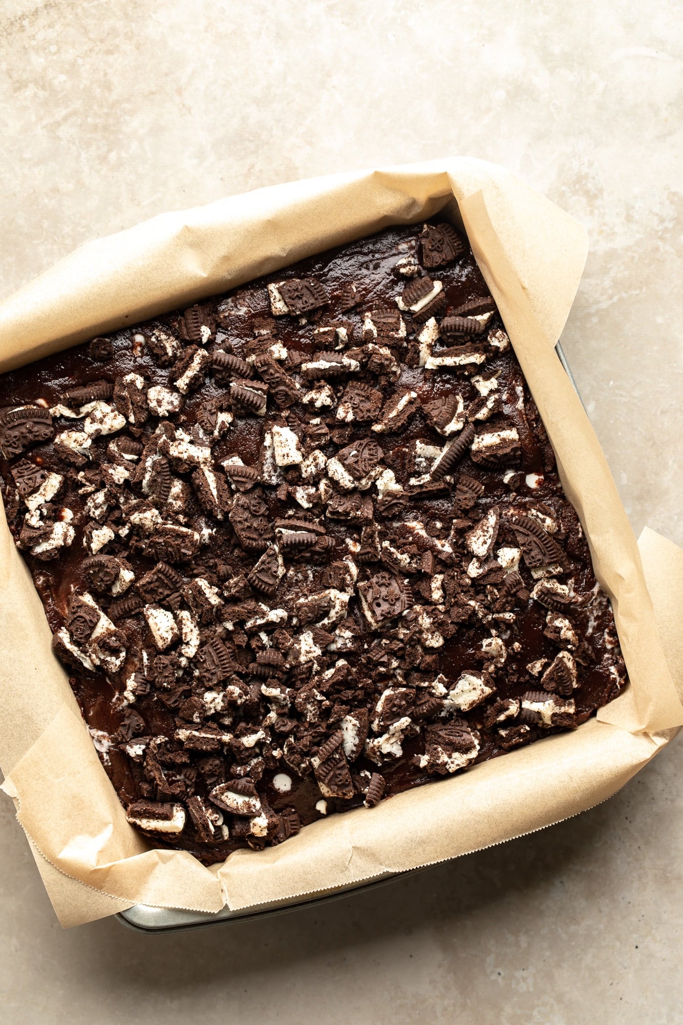 overhead view of unbaked cookies and cream brownies in a baking pan.