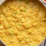 overhead view of vegan potato curry cooking in a large pot.