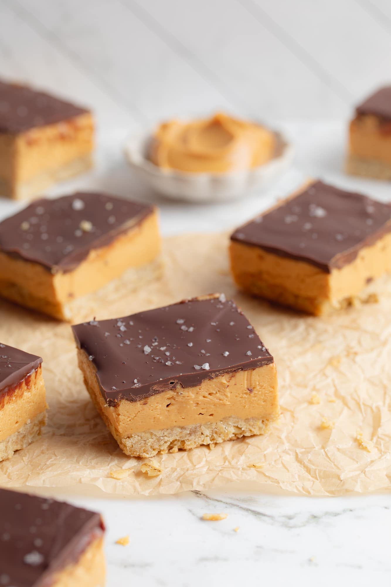 side view of Chocolate Peanut Butter Oatmeal Bars on a piece of parchment paper.