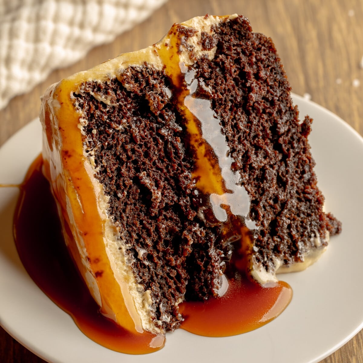 side view of a slice of vegan salted caramel chocolate cake.