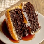 side view of a slice of vegan salted caramel chocolate cake.
