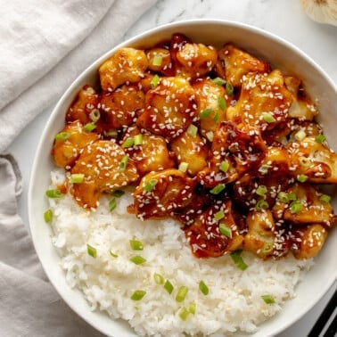 overhead view of sesame cauliflower in a bowl with rice.