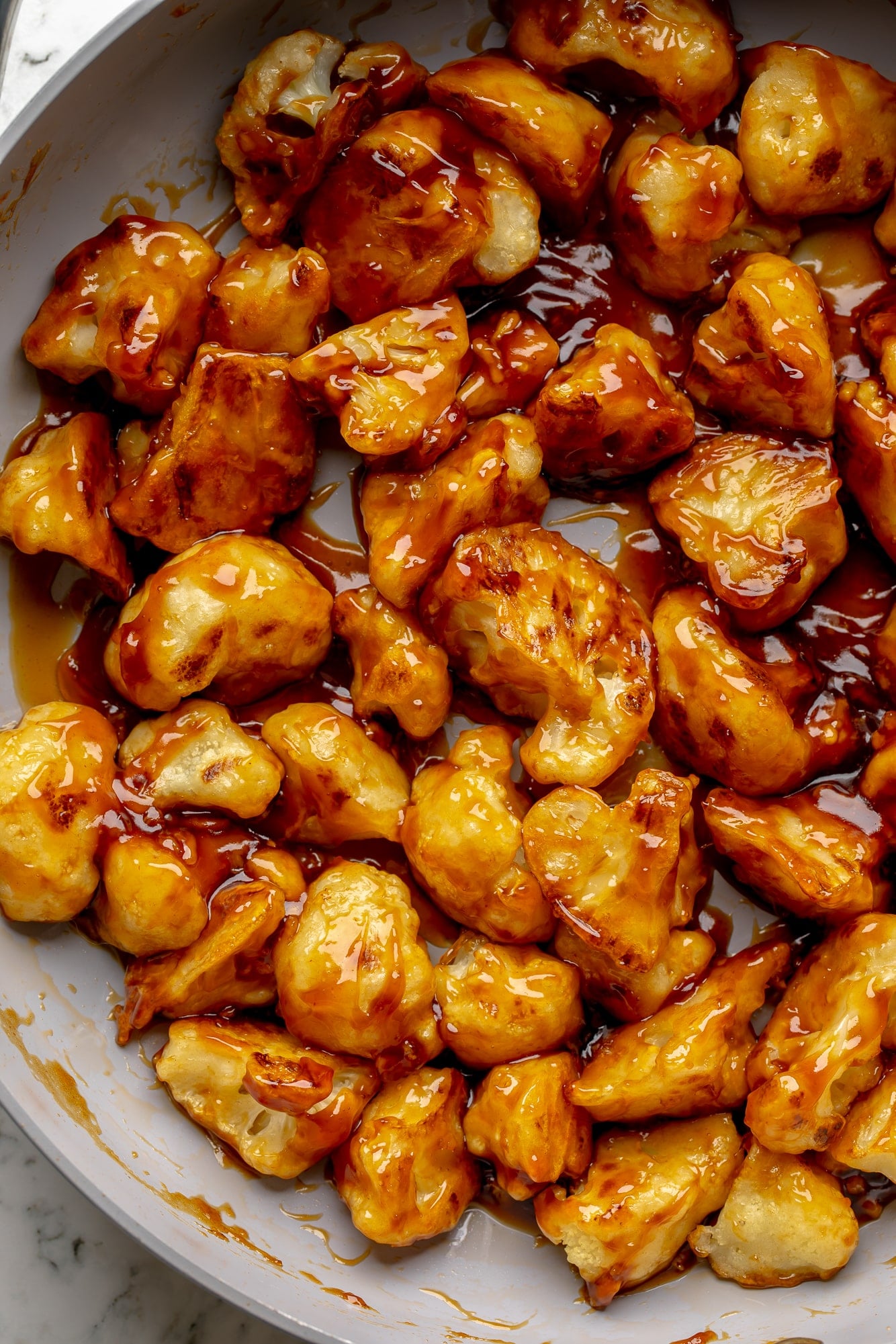 overhead view of sesame cauliflower in a skillet.