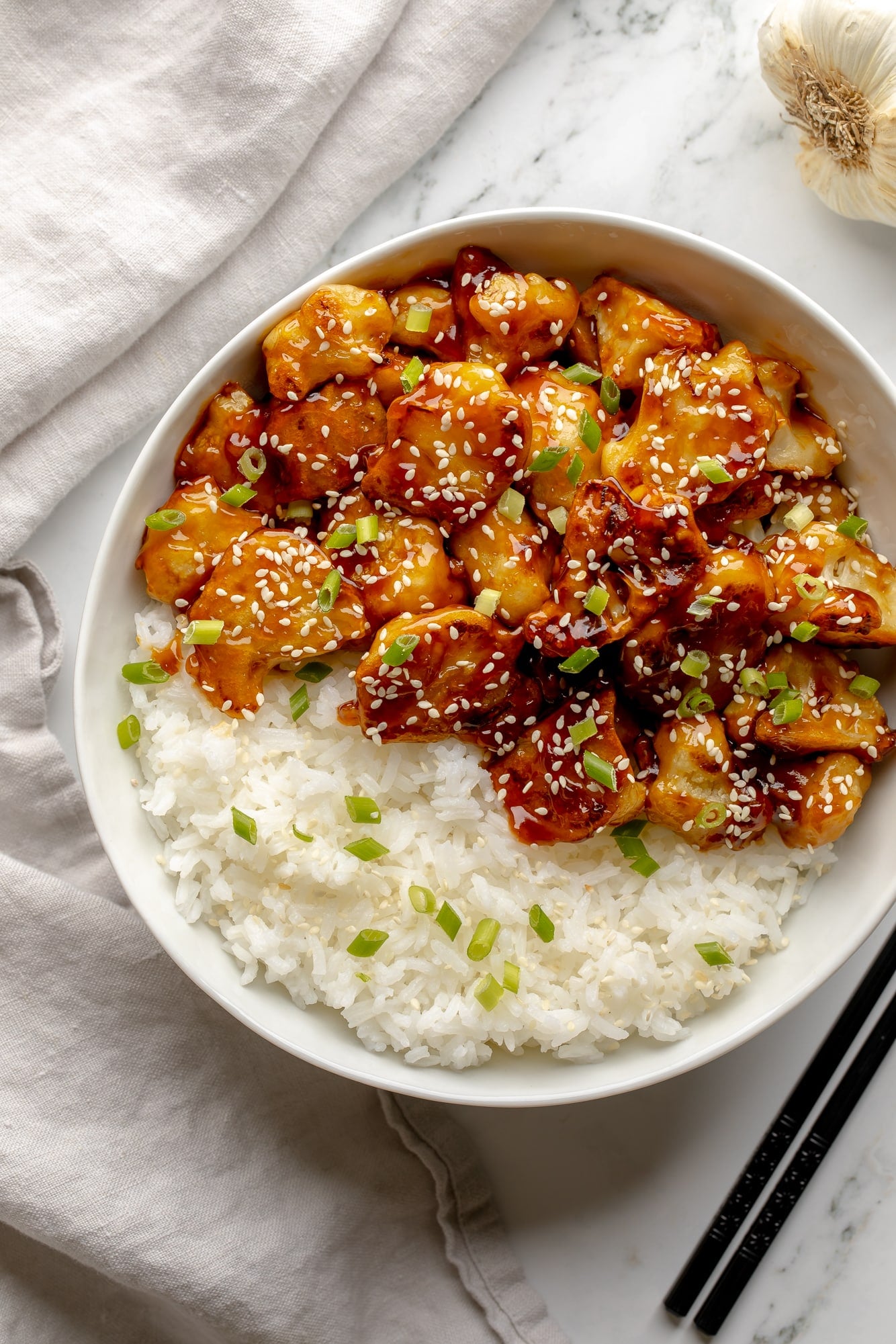 overhead view of sesame cauliflower in a bowl with rice.