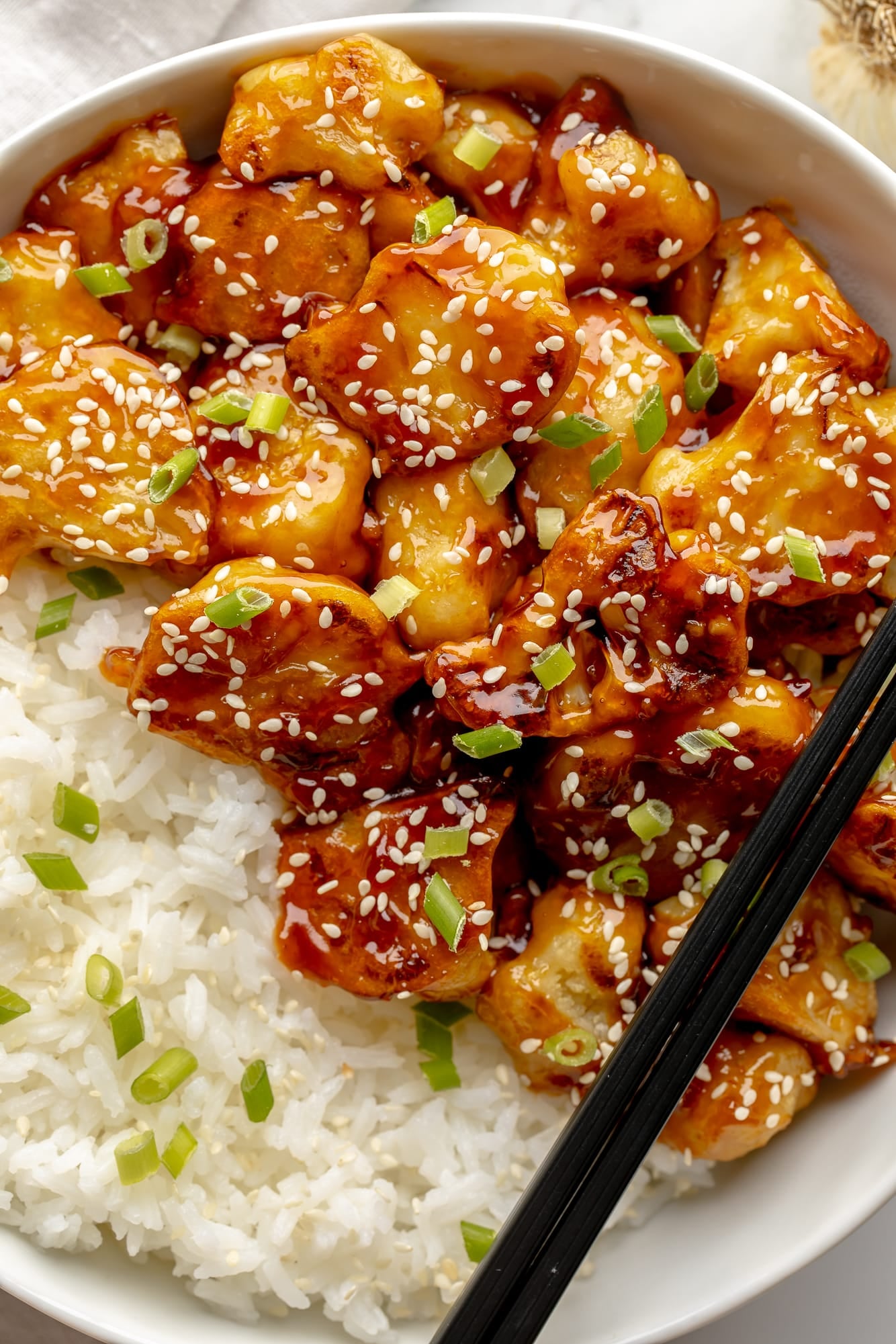 overhead view of sesame cauliflower in a bowl with rice.