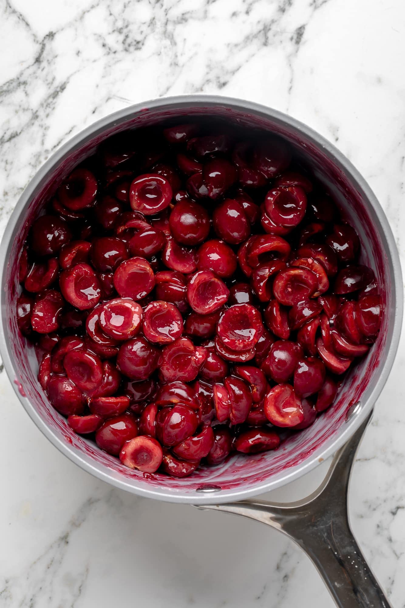 overhead view of the cherry filling ingredients for vegan cherry cobbler in a saucepan.