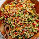 overhead view of a mixed Mediterranean Chickpea Salad in a large bamboo bowl.