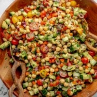 overhead view of a mixed Mediterranean Chickpea Salad in a large bamboo bowl.