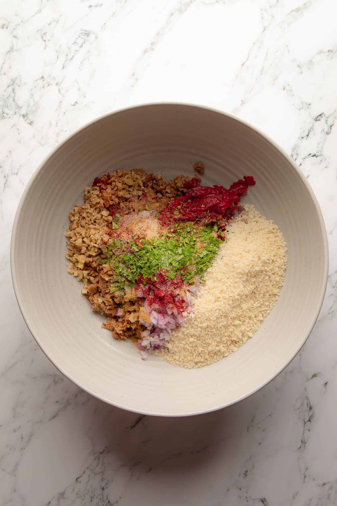 overhead view of the ingredients for lentil burgers in a large bowl.