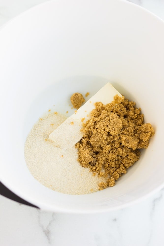 overhead view of the wet ingredients for vegan pumpkin cookie dough in a large white bowl.