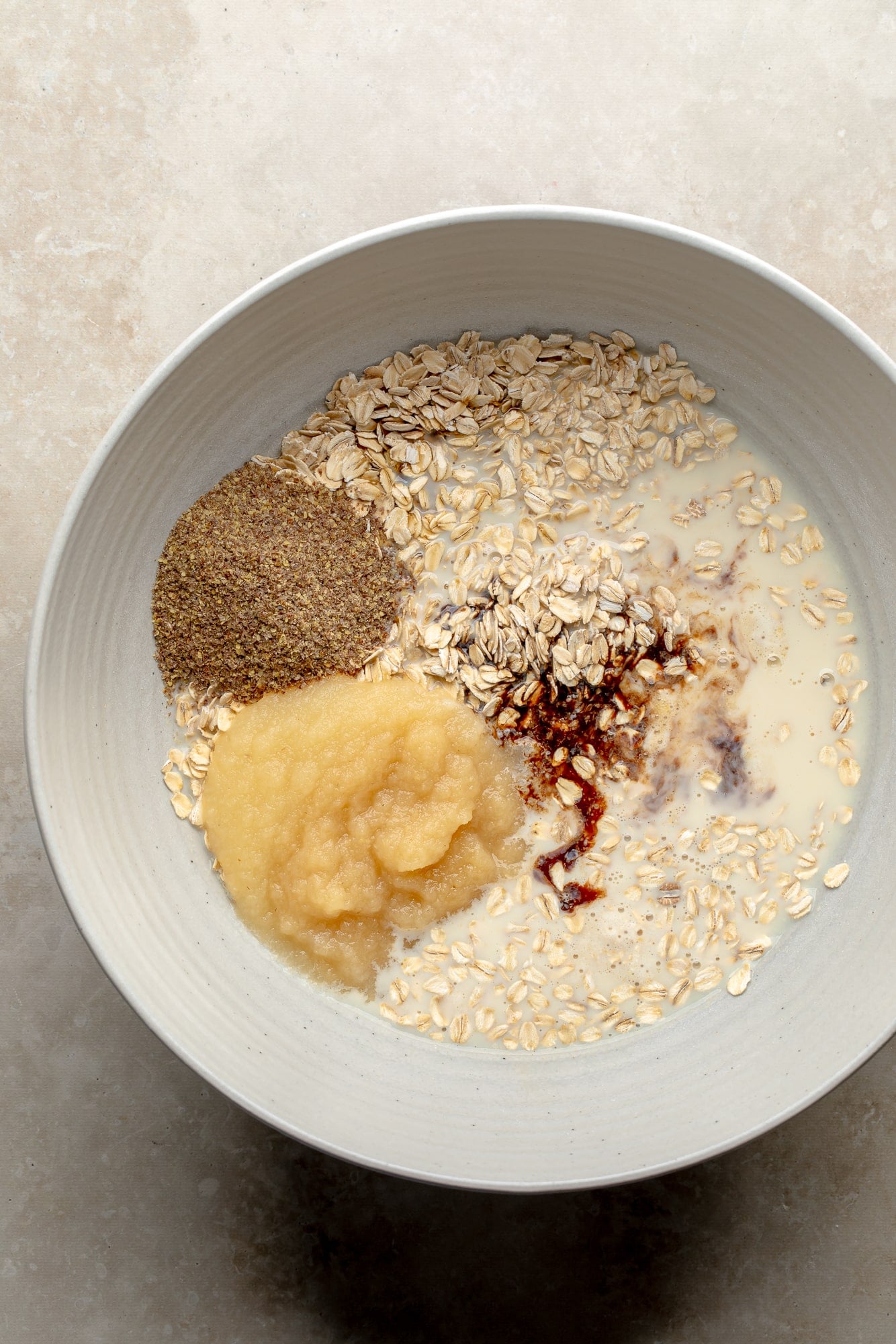 overhead view of the ingredients for baked berry oatmeal in a large bowl.