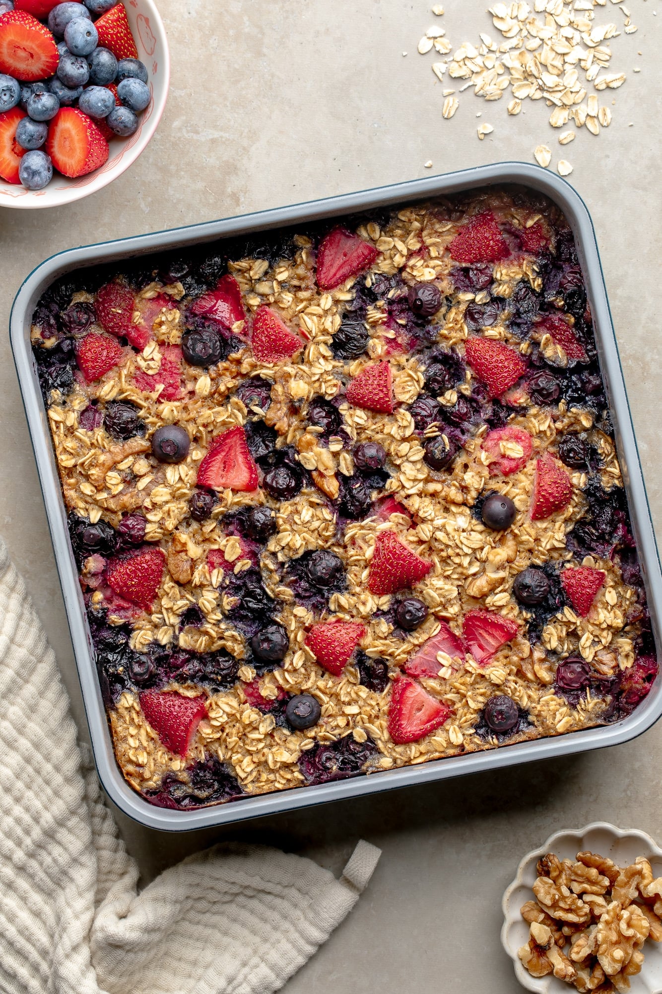 overhead view of baked berry oatmeal in a square baking pan.