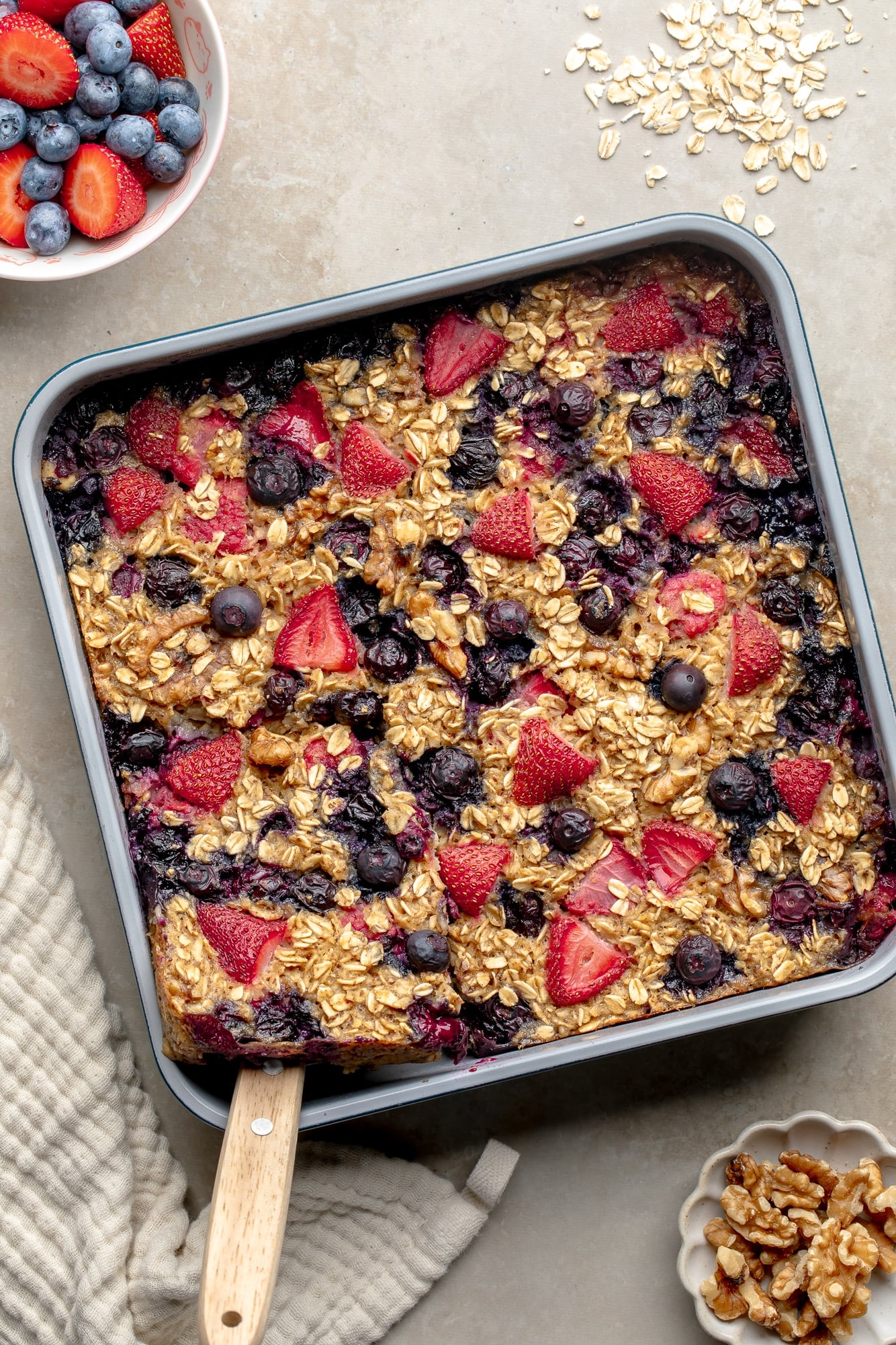 overhead view of baked berry oatmeal in a square baking pan.