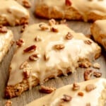 square image of a vegan maple pecan scone topped with maple glaze and chopped pecans.